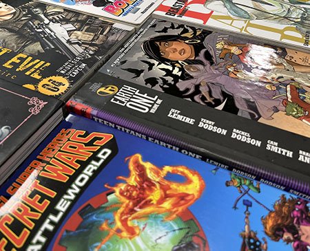 Several graphic novels spread edge to edge